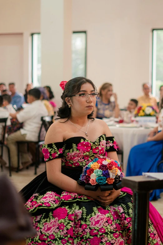 a woman in a dress with flowers in her hair and a large pink bouquet in her hands