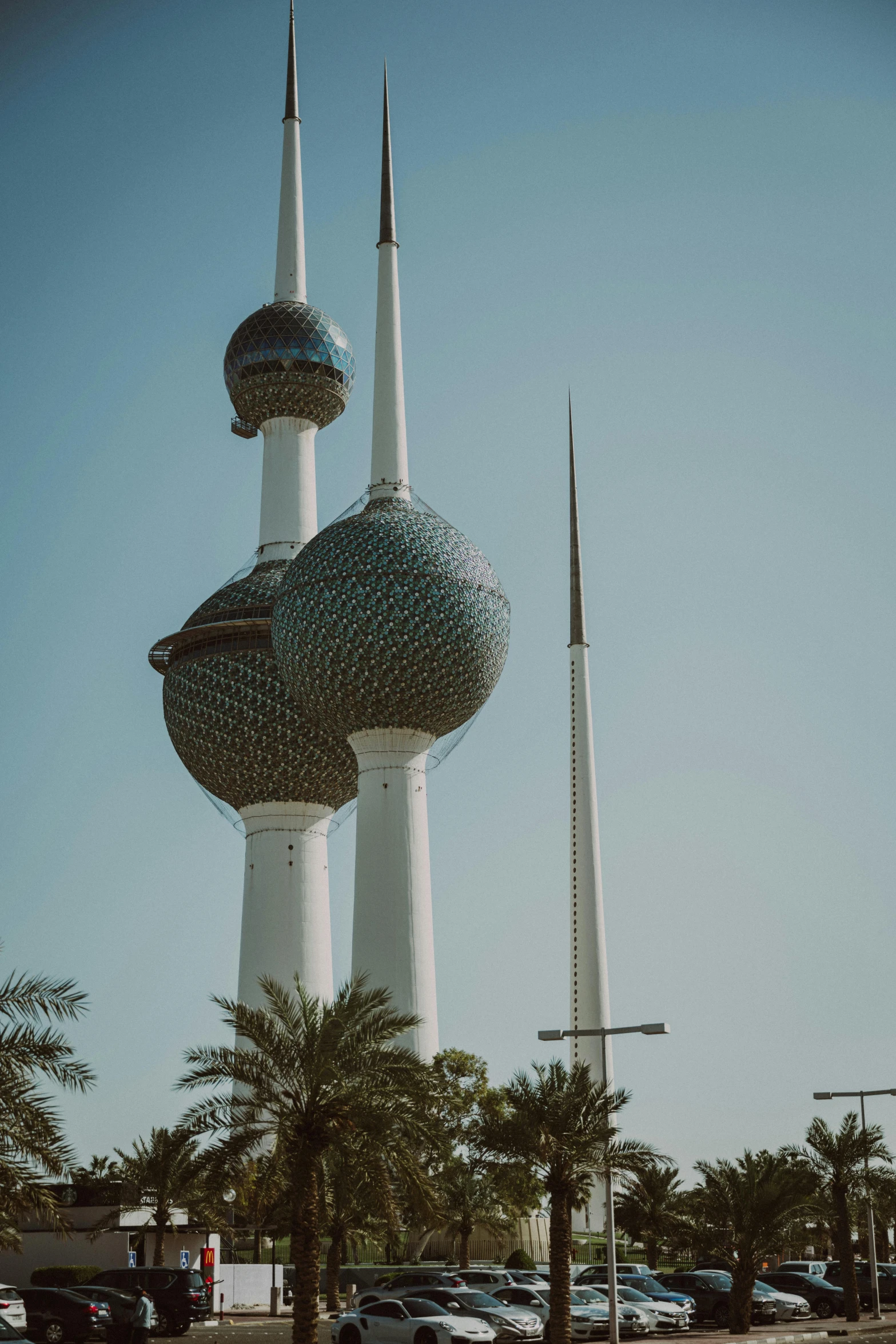 a car is driving past some futuristic buildings