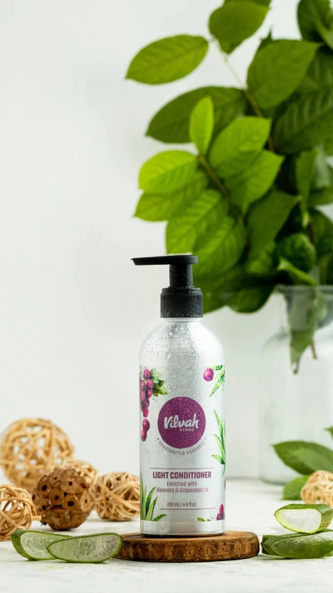 a bottle of body lotion with a green plant in the background