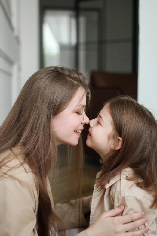 a girl kissing another pretty little girl