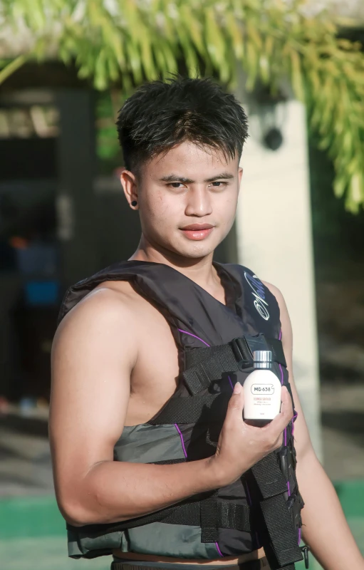 a young man is holding a microphone and a bag