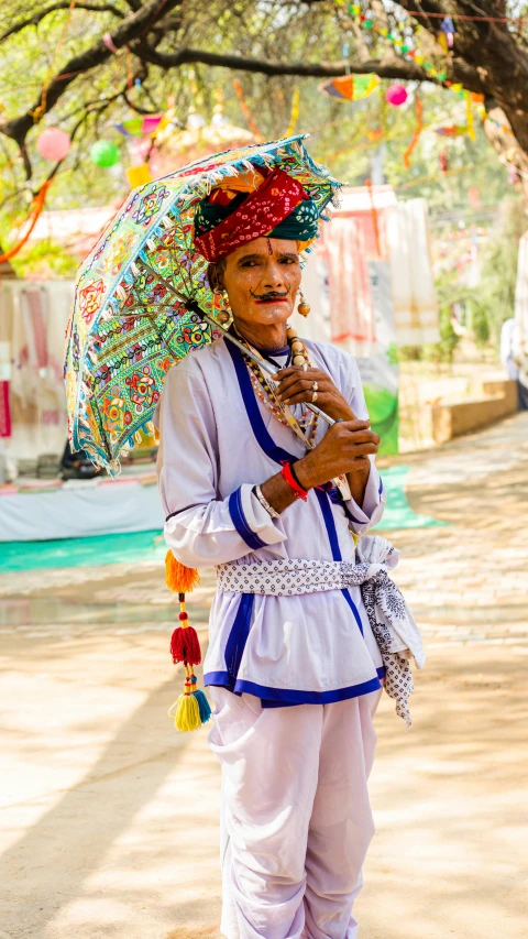 a woman carrying an umbrella is wearing clothes made of multicolored beads