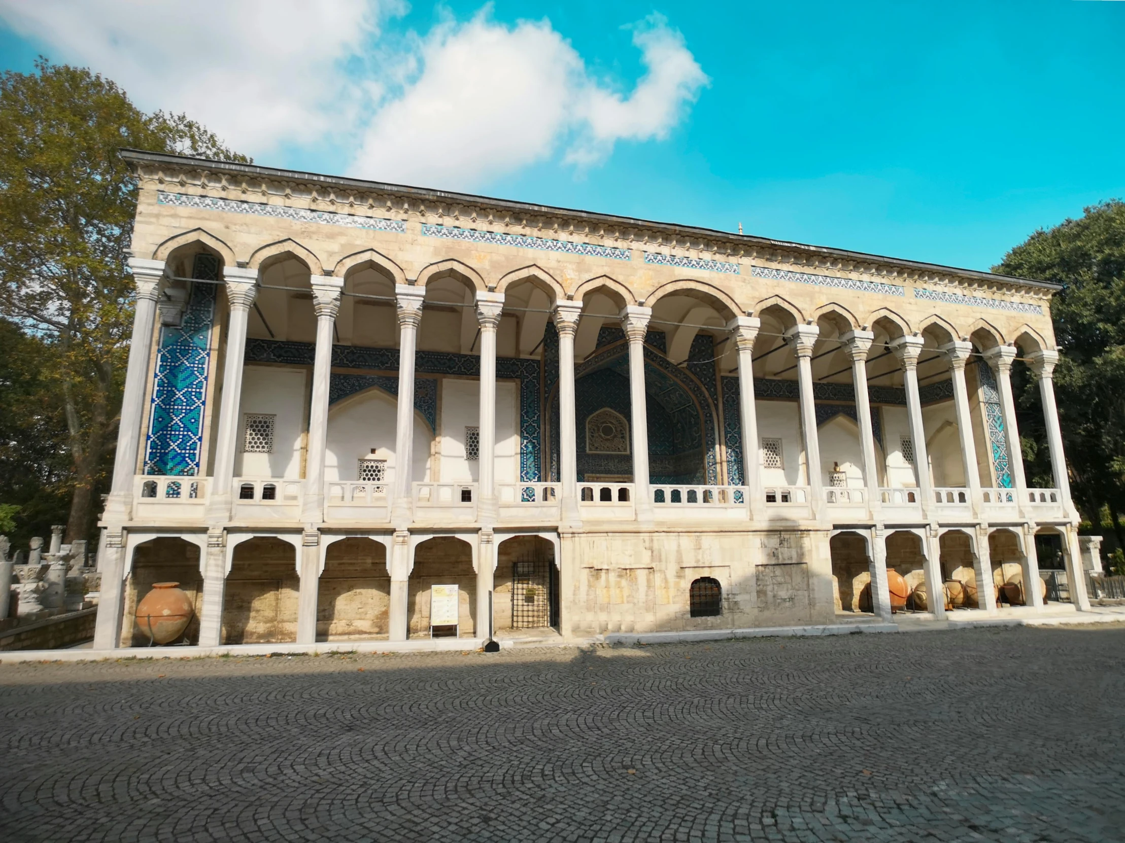 a large white and beige building with columns