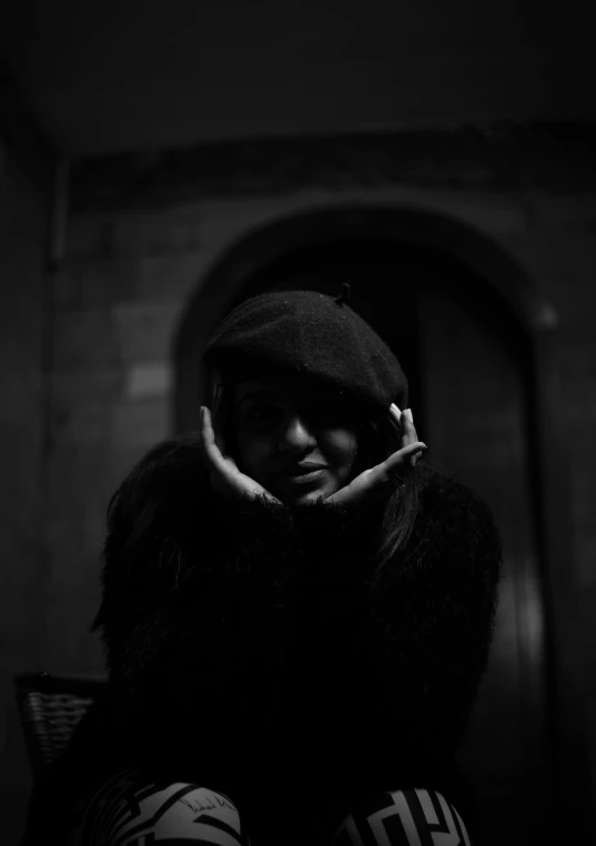 woman in long fur jacket standing in front of door