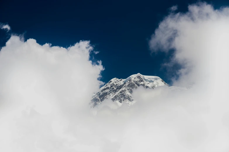 a cloud that is hovering over a mountain