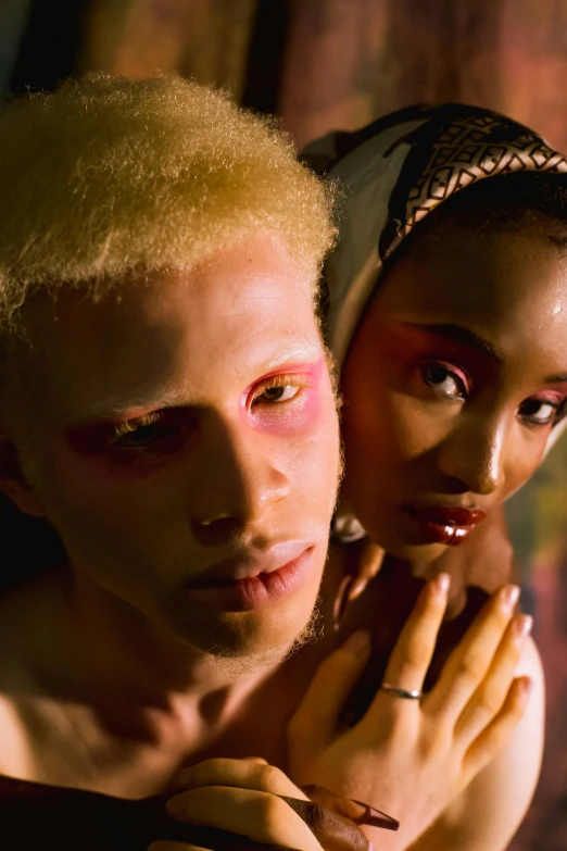 a young couple wearing makeup are posing for the camera