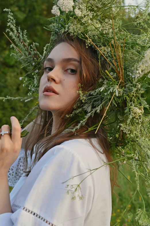 a woman holding a ring while standing in grass