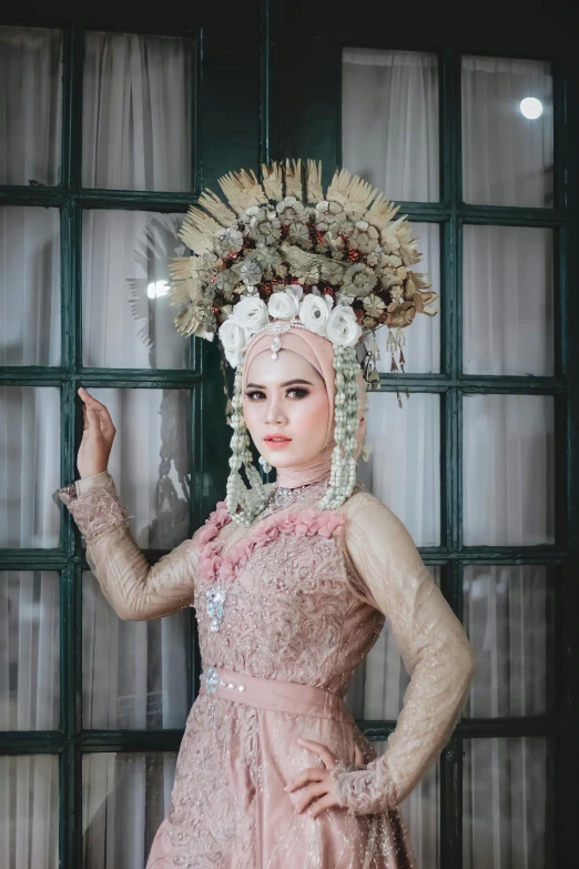 a woman dressed in an elaborate dress posing for a picture