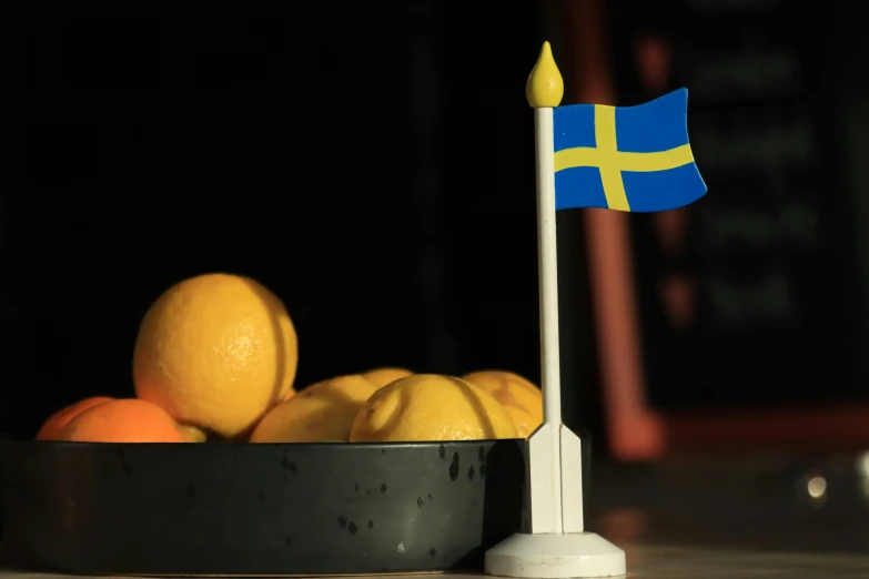 a swedish flag is on top of some lemons