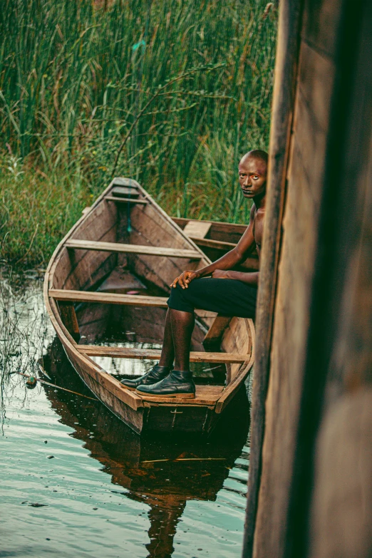 a man sits in his boat on the water