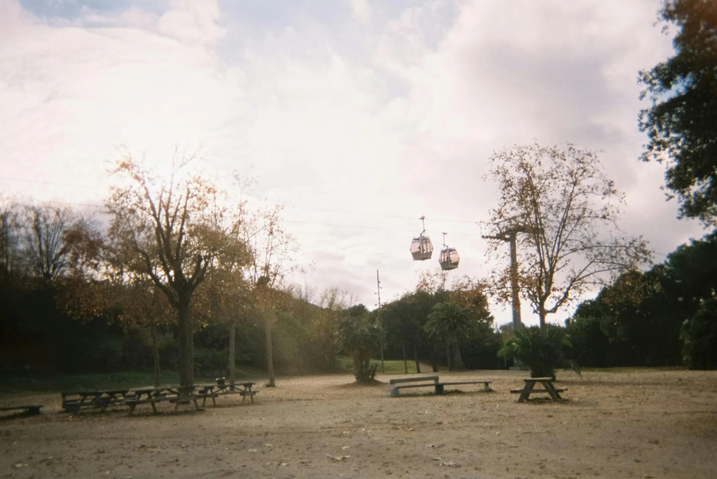 many empty benches around in a dirt field