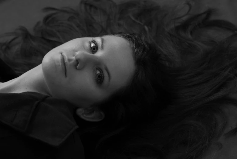 black and white pograph of a woman lying on the floor