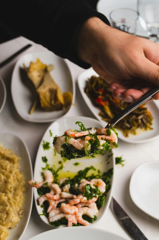 a hand is pulling soing off of the plate