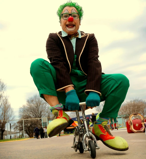 an evil clown with green hair and nose riding a bicycle