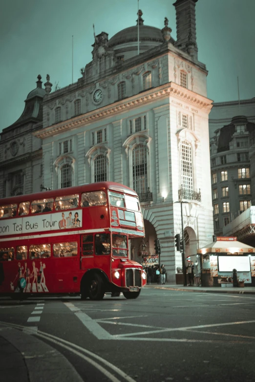 a double decked bus parked outside an old building