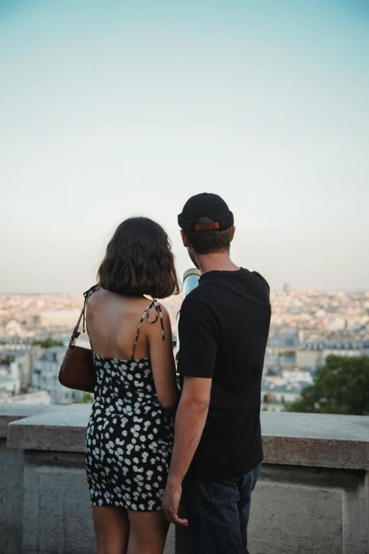 two people who are standing together overlooking a city