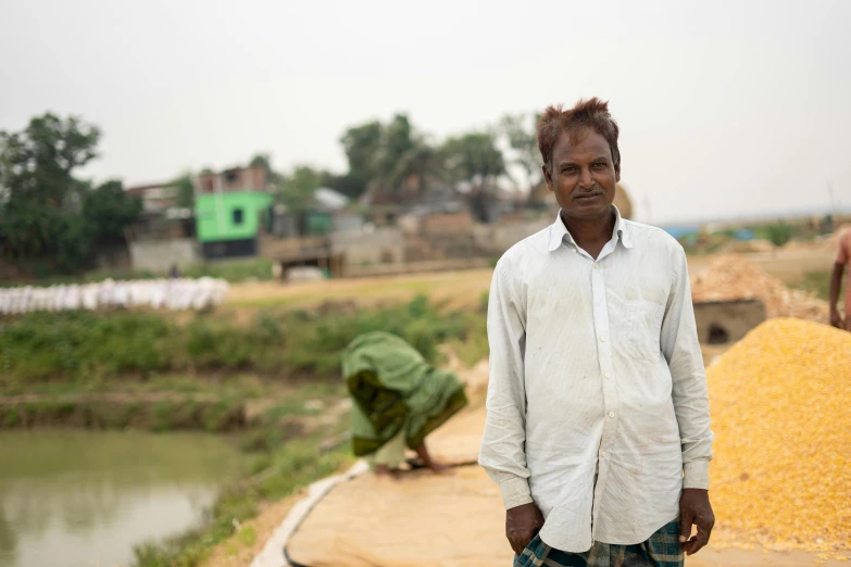 a man stands in front of some corn