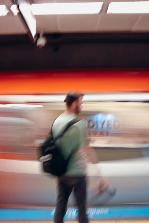 a man walking with a bag and suitcase behind him