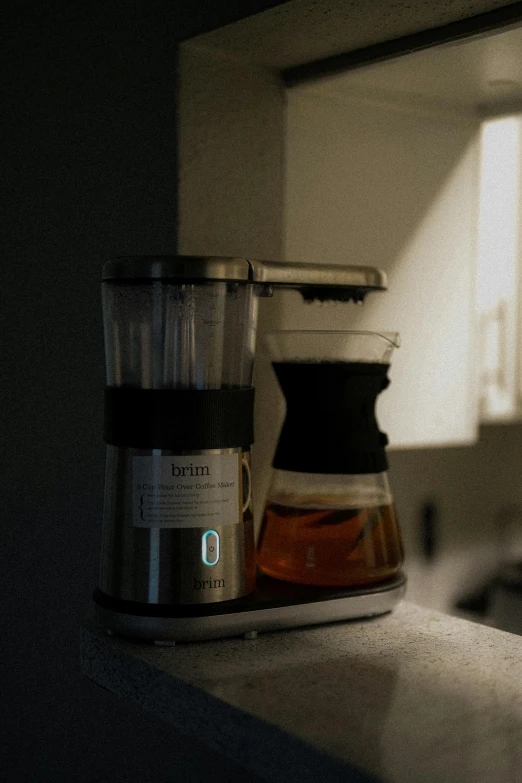 a black and silver coffee maker is on a counter