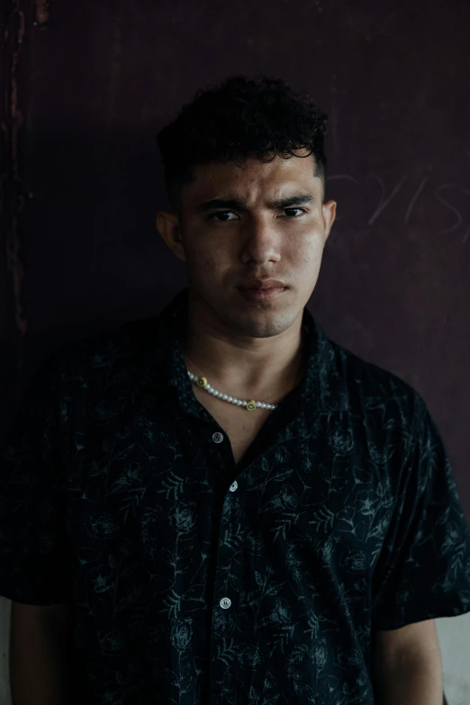 a man with black shirt and a necklace