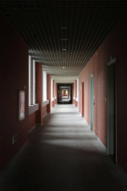 a long hallway with a tile ceiling and two blue doors