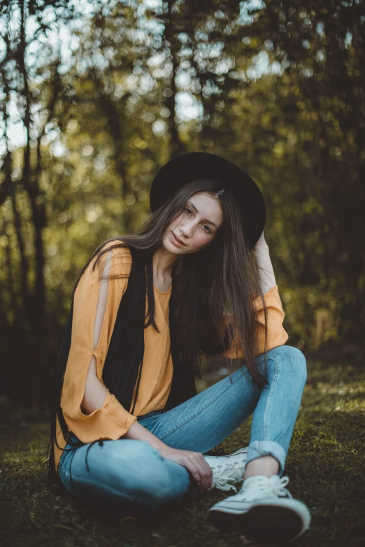 a girl wearing a hat in the woods