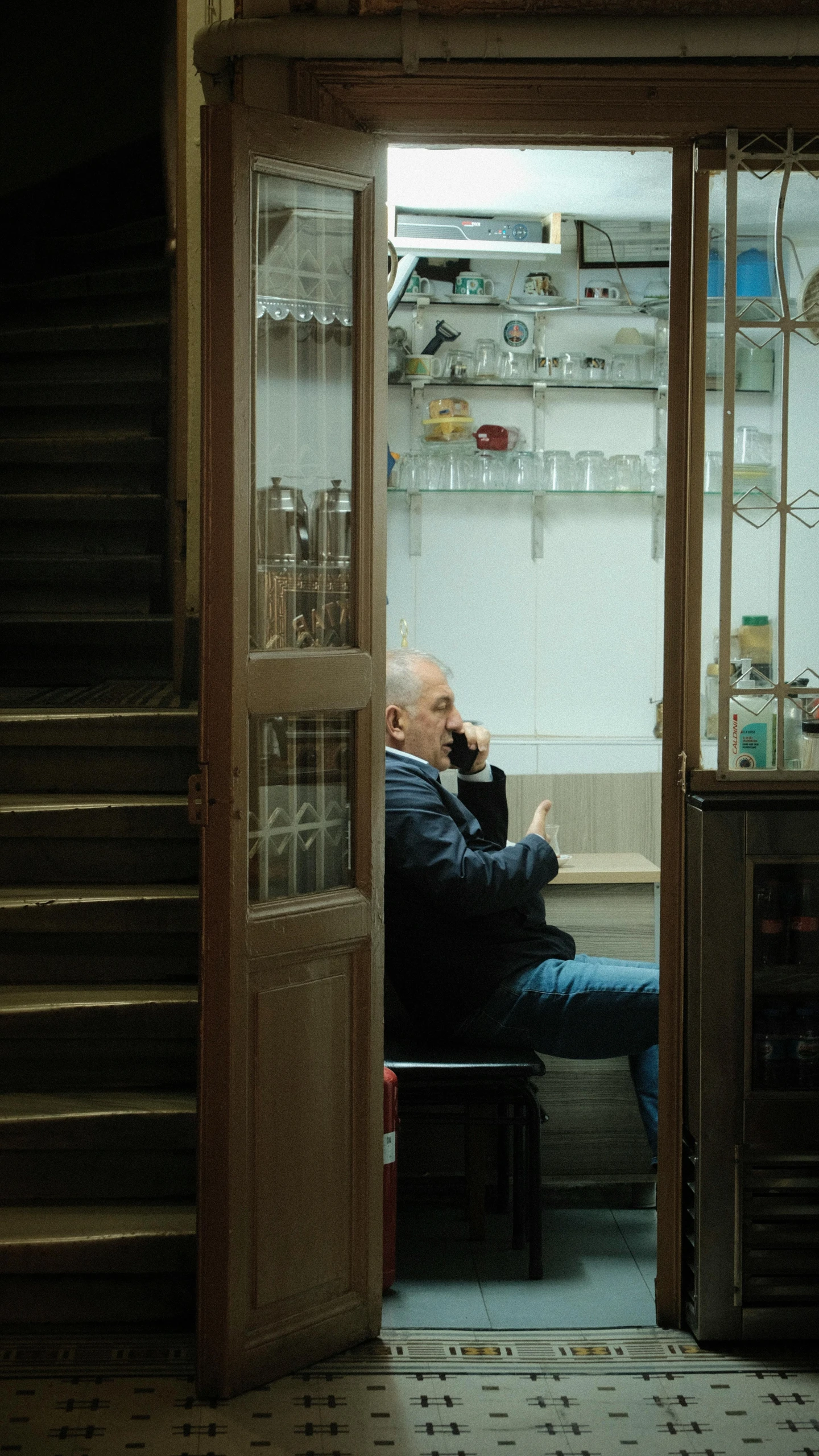 a person sitting on the couch in a doorway