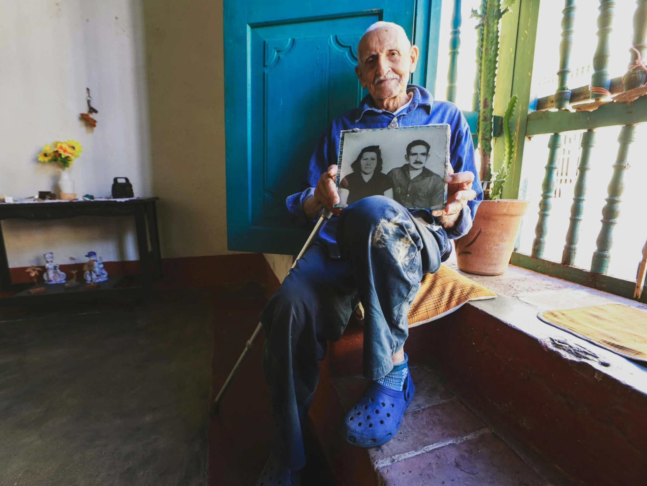 a person sitting on a bed with a picture