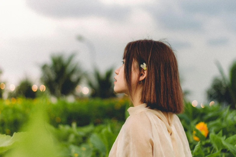 a woman with short hair in a field