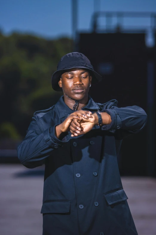 a person posing for a picture while wearing a hat