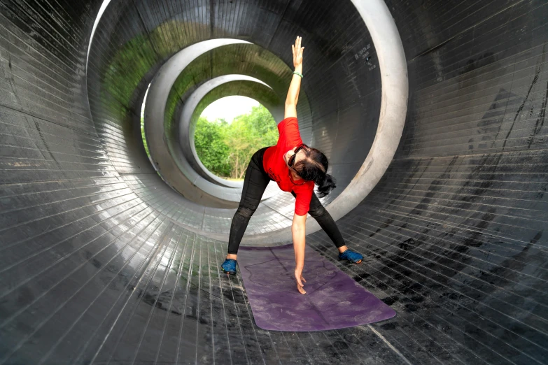 woman in red shirt doing yoga on purple mat