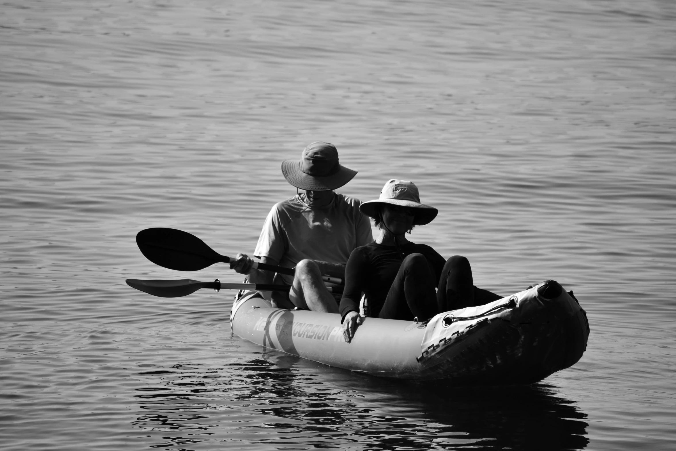 three people are paddling on a kayak in the water