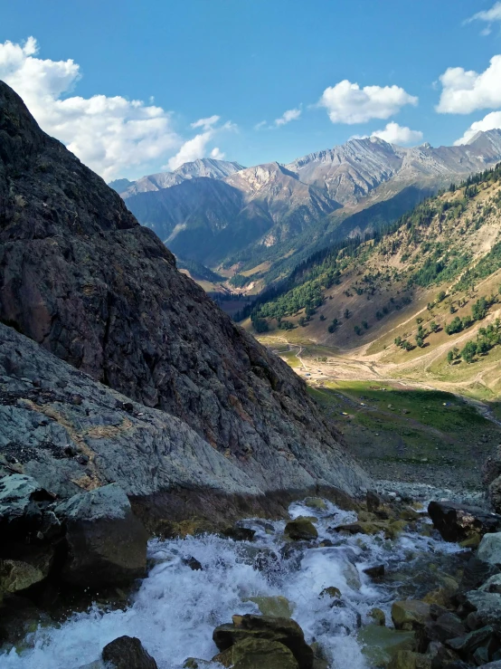 some water flowing in a river near mountains