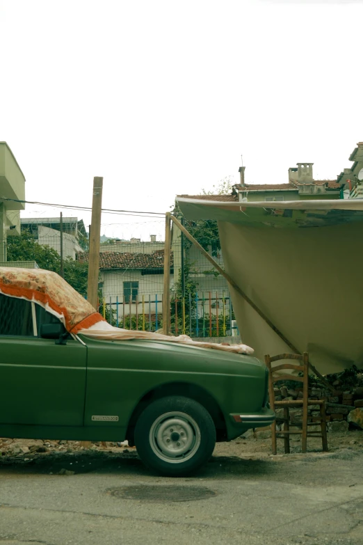 a car is parked by a boat on the street