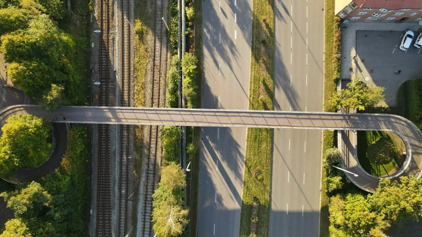 an aerial view of a railroad crossing and train tracks