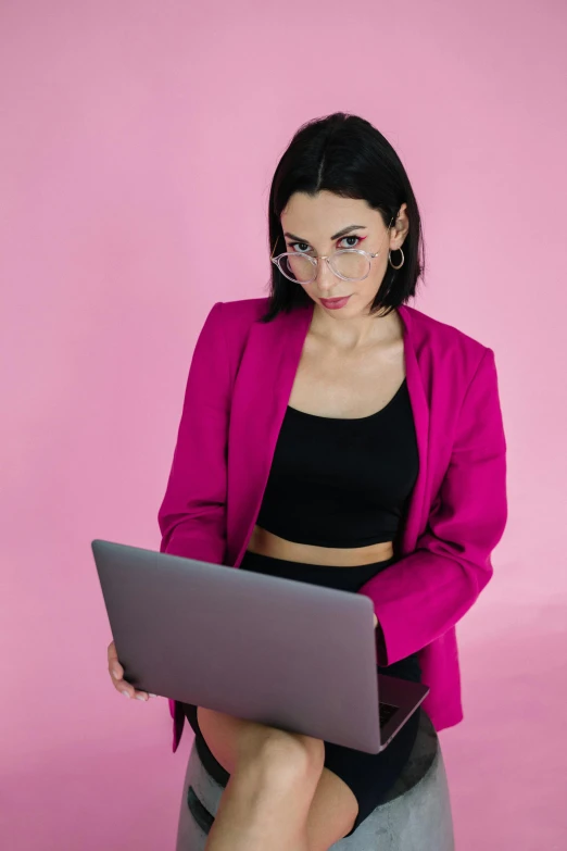 a girl with some fake glasses holding a laptop