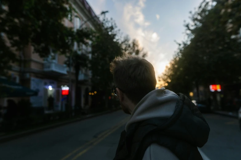 a man walks down the street with a cellphone in his hand