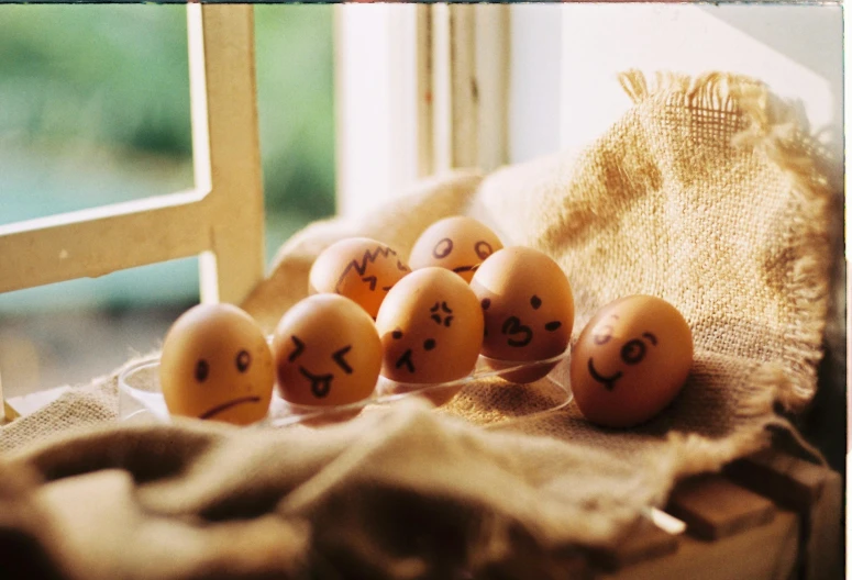 eggs with faces drawn on them sit next to a chair