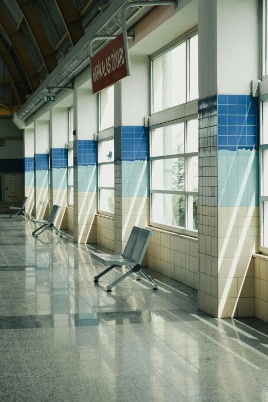 an empty bench sitting on the floor in a train station