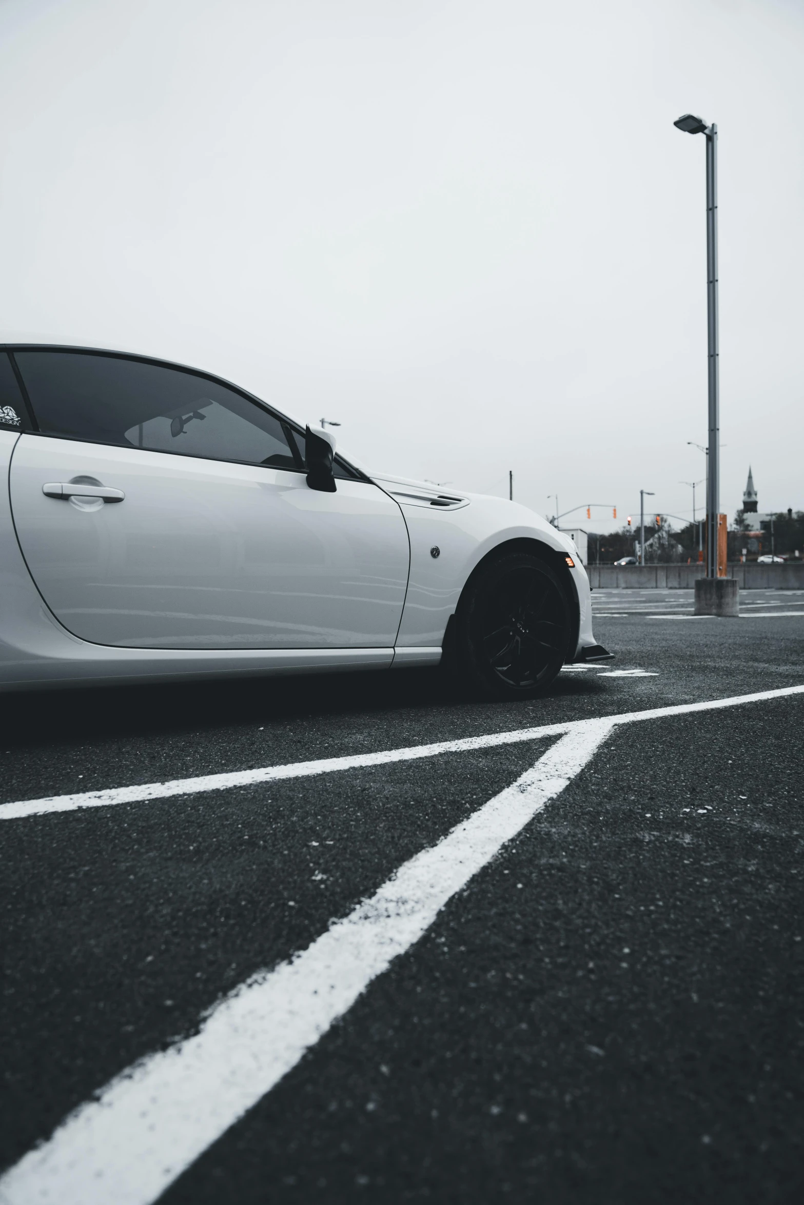 a white car parked on the street in a parking lot