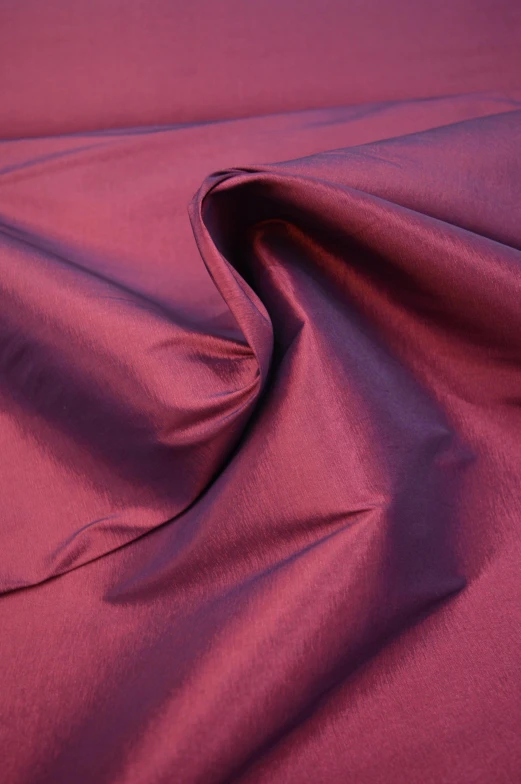 a plain deep red fabric has been folded