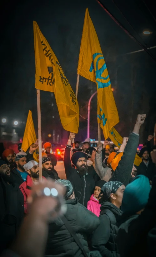 a group of people with signs waving in the air