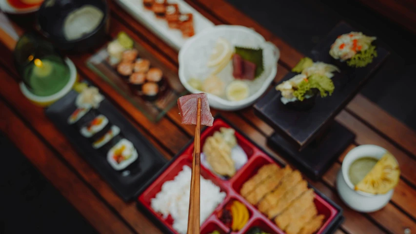 japanese dishes and chopsticks spread out on a table