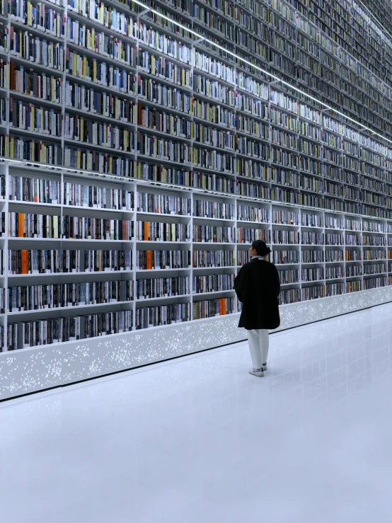 a person walking next to a book shelf filled with books