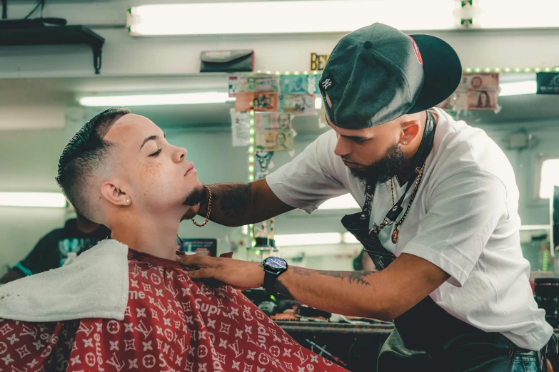 a person getting hair cut by another persons in the background