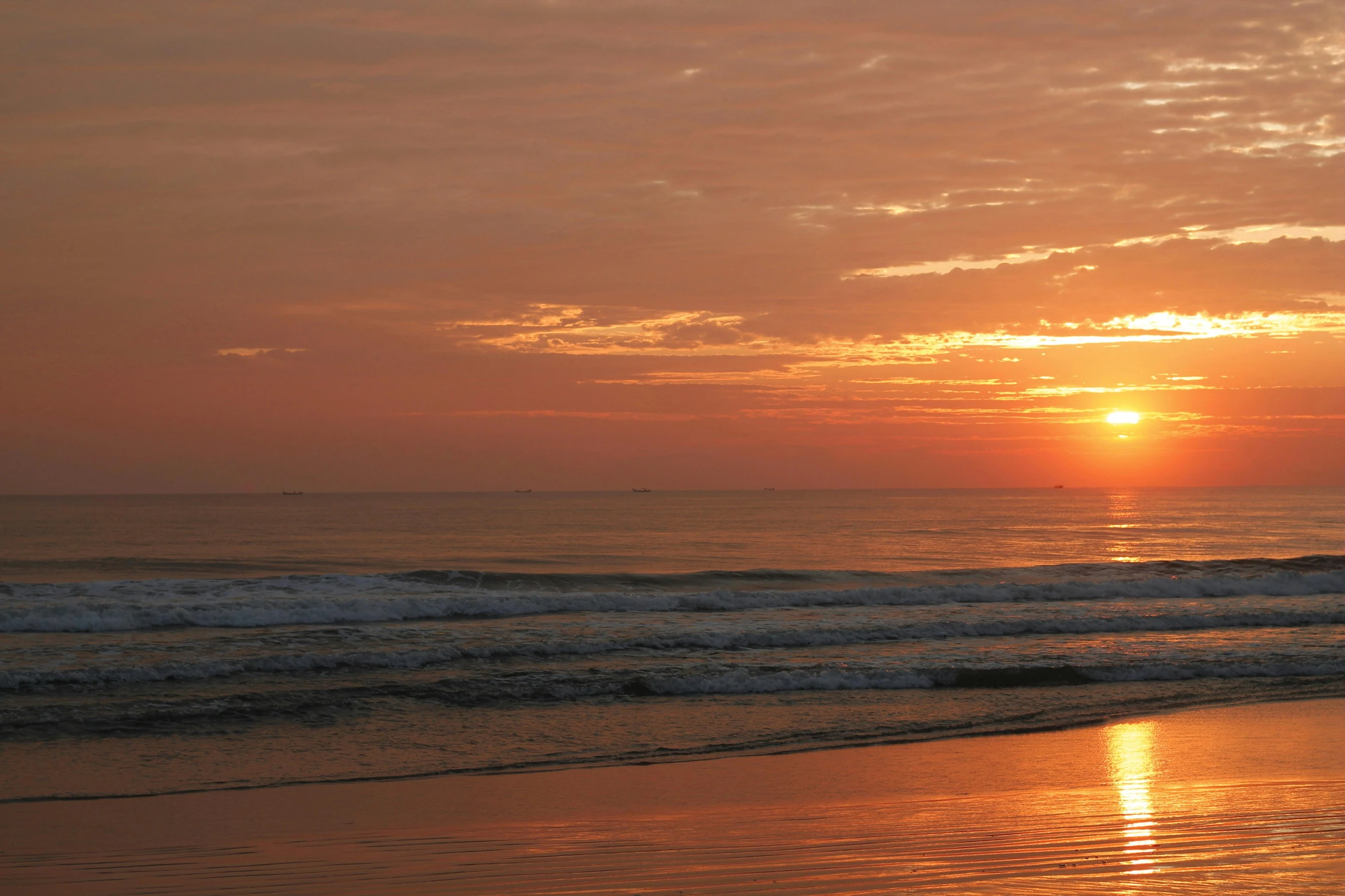 a lone person holding a surfboard on the ocean