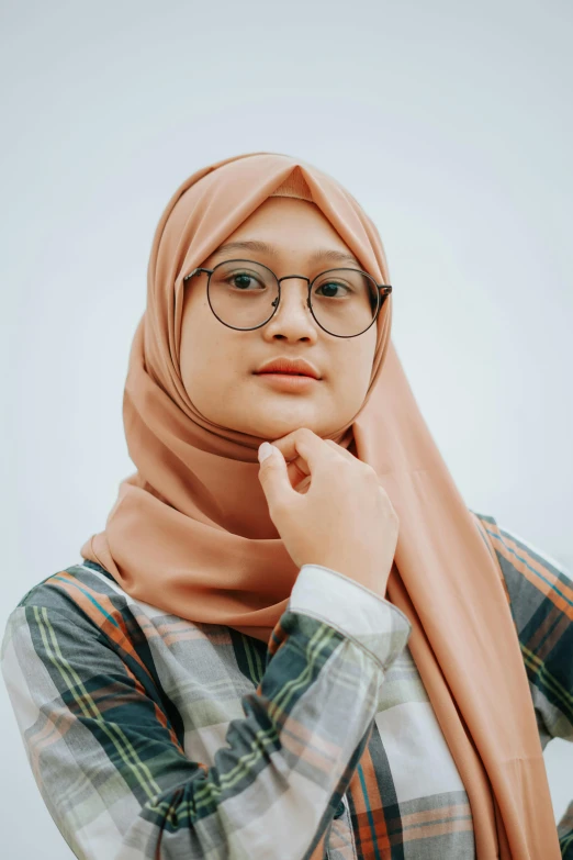 this woman is wearing glasses and wearing a hijab