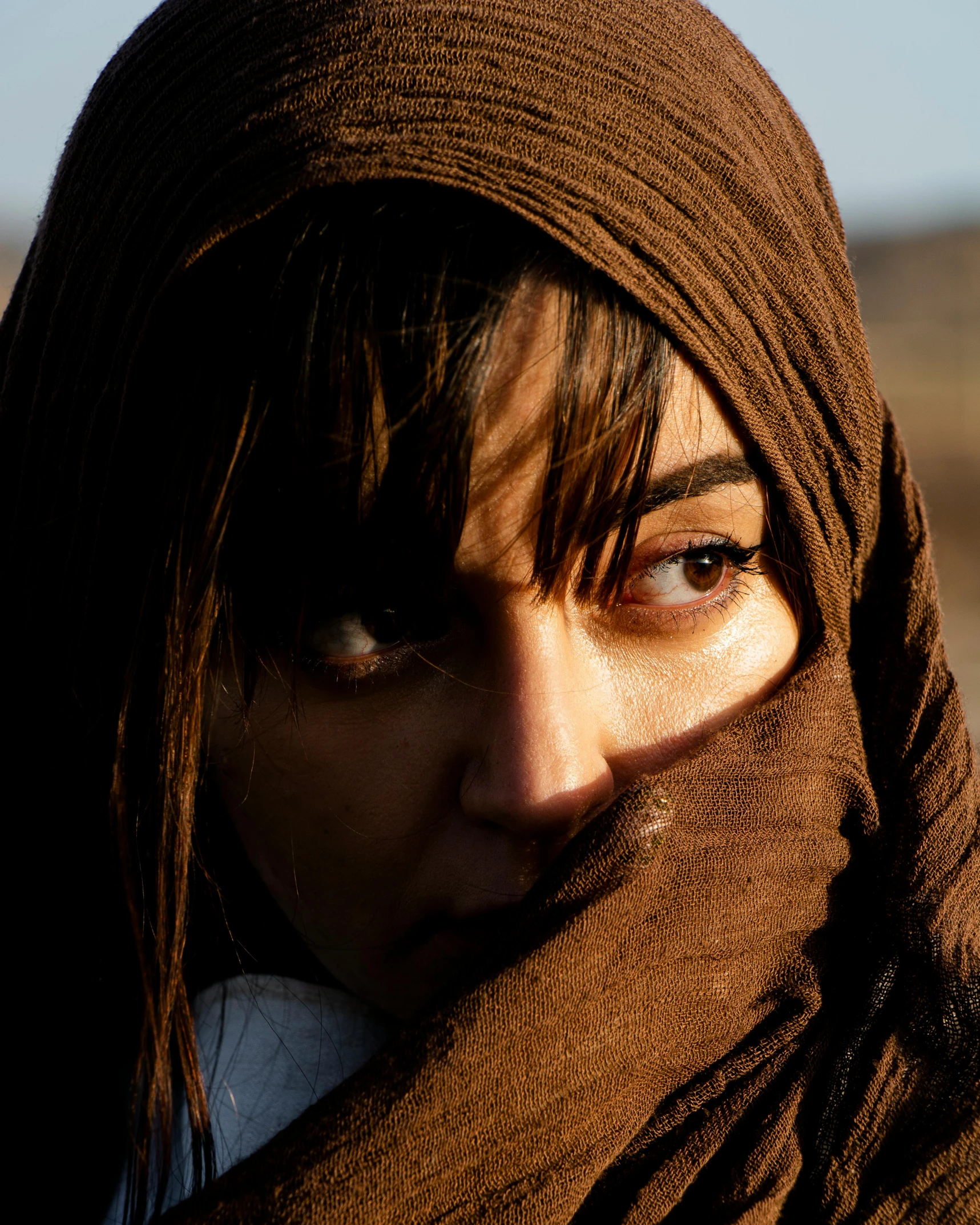 a close up view of a woman wearing a shawl