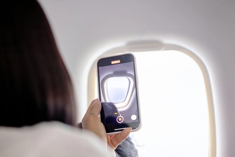 a person taking a po from inside an airplane window