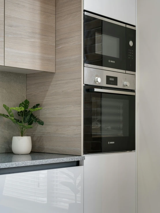 two stainless steel microwaves are shown next to each other